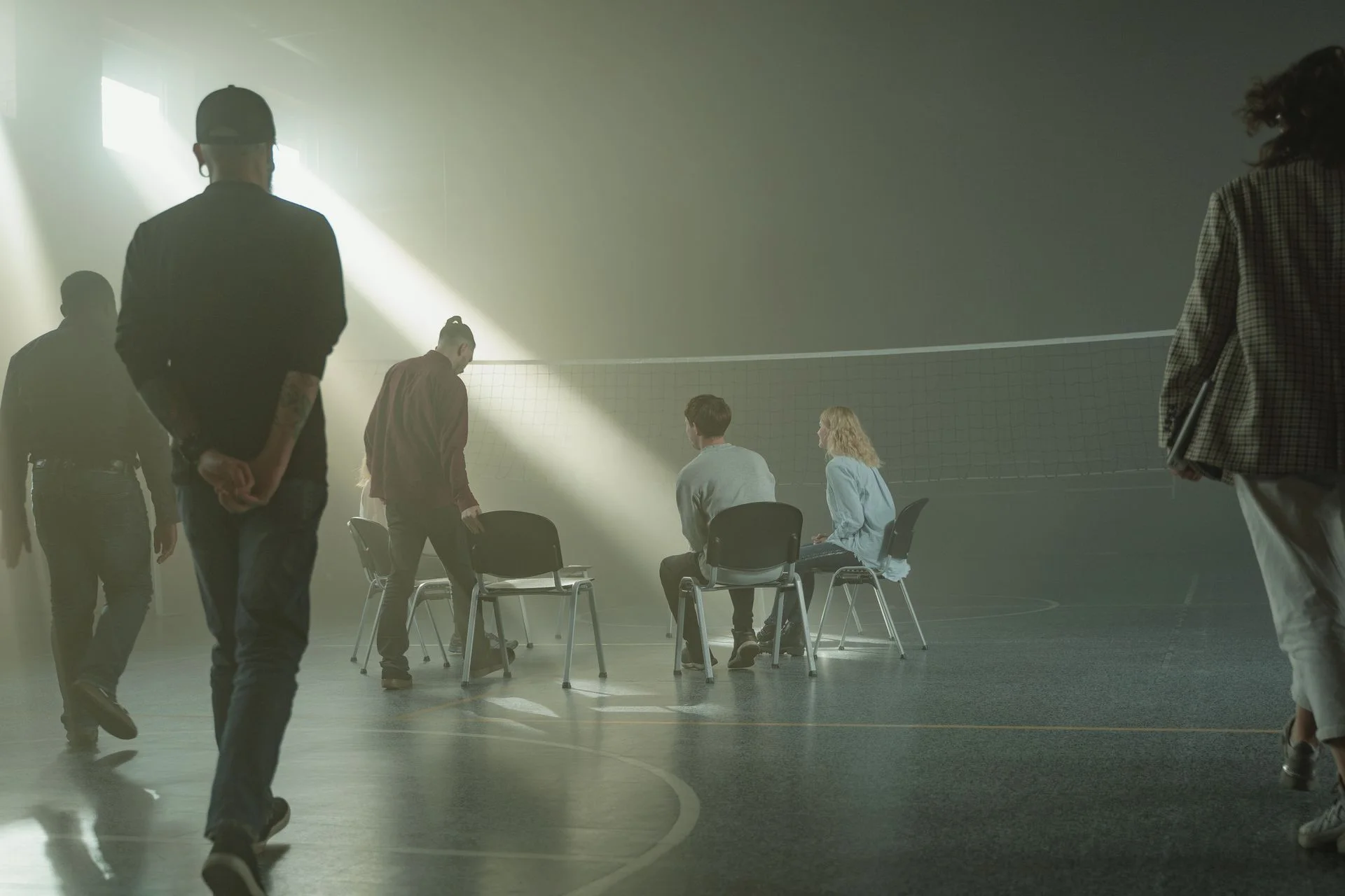 An adult discussion circle in a softly lit room