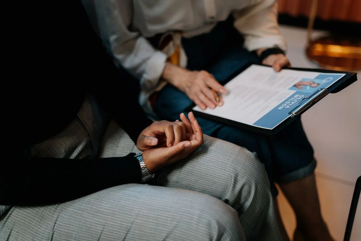 Hands reviewing paperwork during a meeting