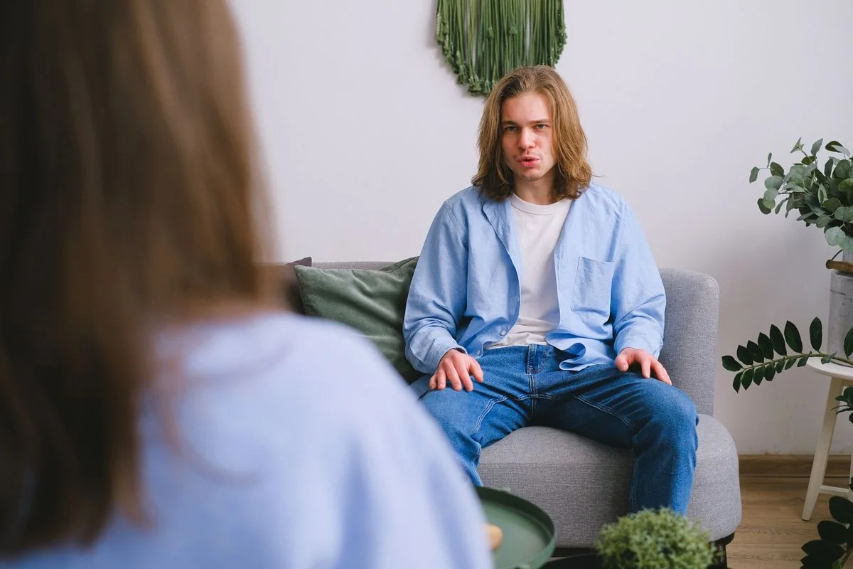 An adult talking with a counselor in a bright quiet room
