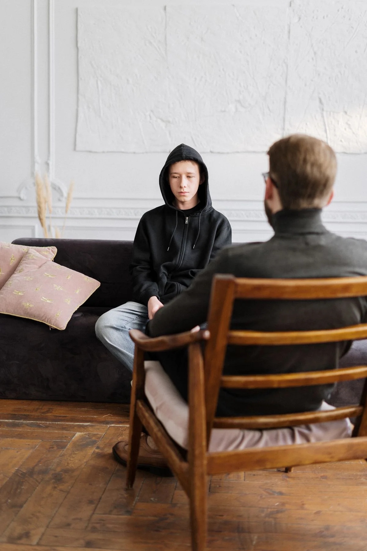 Two adults talking openly in a softly lit office