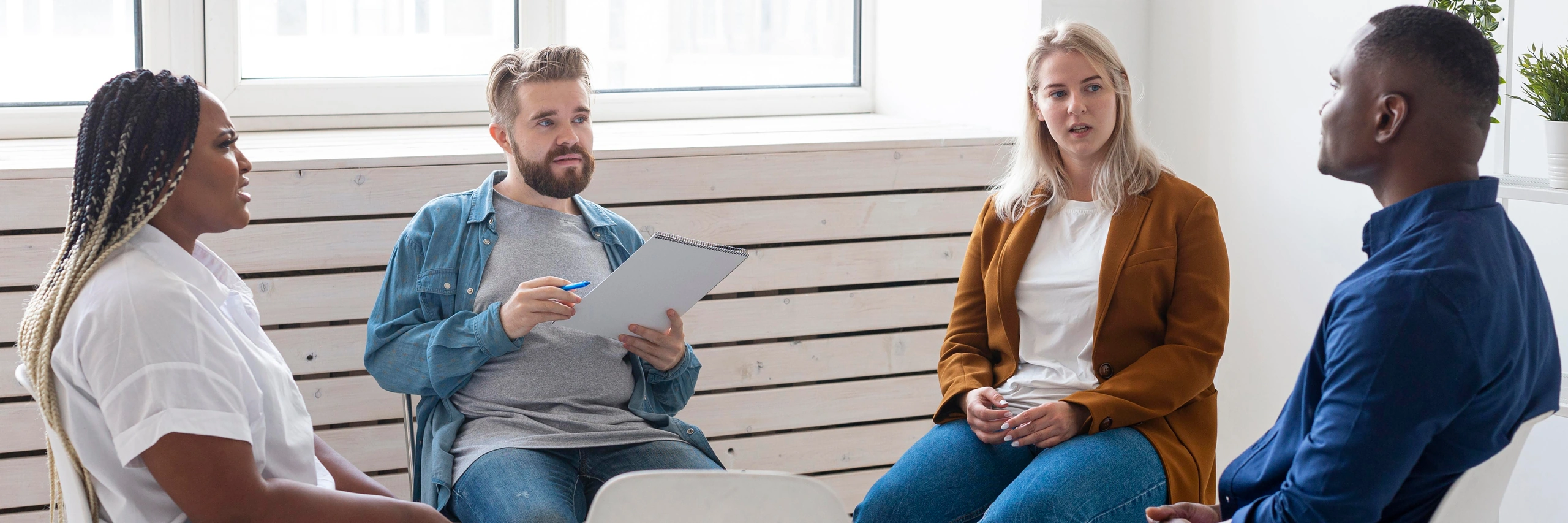 Adults talking together in a group therapy session