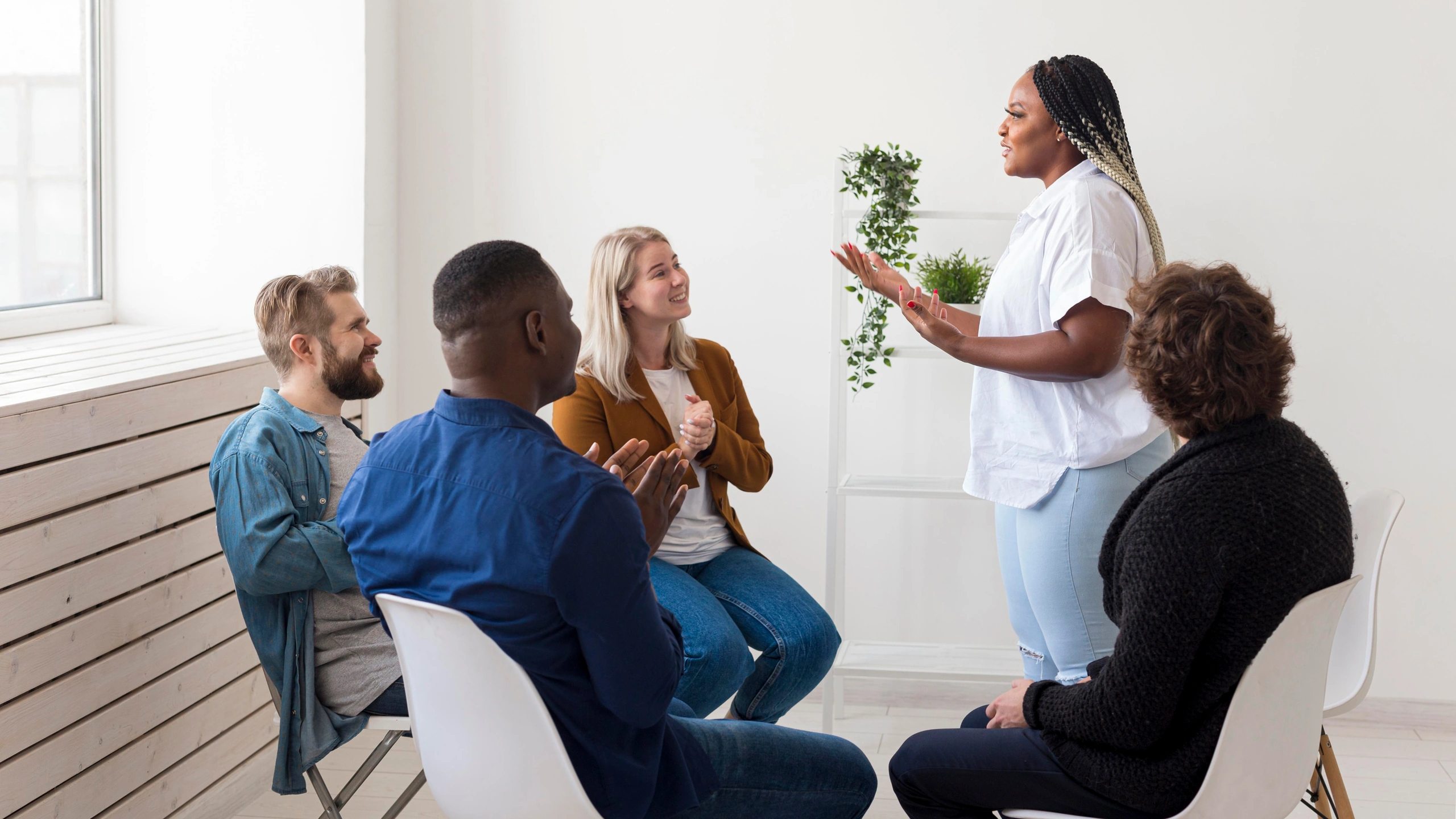 Adults taking part in a group therapy session